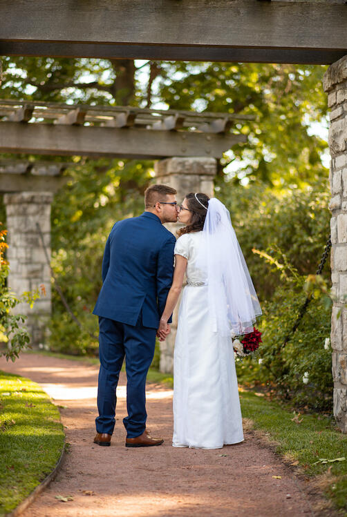 wedding couple kissing in garden